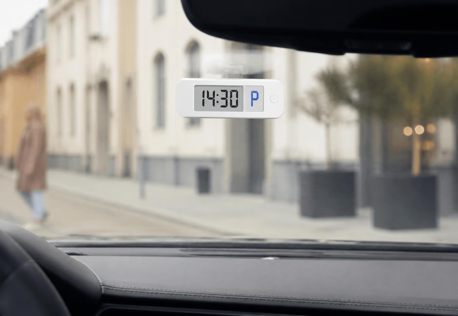 SmartParkClock automatic electronic parking clock mounted inside a car windshield showing 14:30